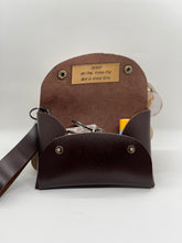 Load image into Gallery viewer, Brown leather pouch with a strap, containing items, on a white background.