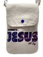 Canvas cross-body bag with 'Freedom is... Jesus All Day' text on a white background