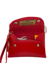 Load image into Gallery viewer, Red leather pouch with a gold tag on a white background

